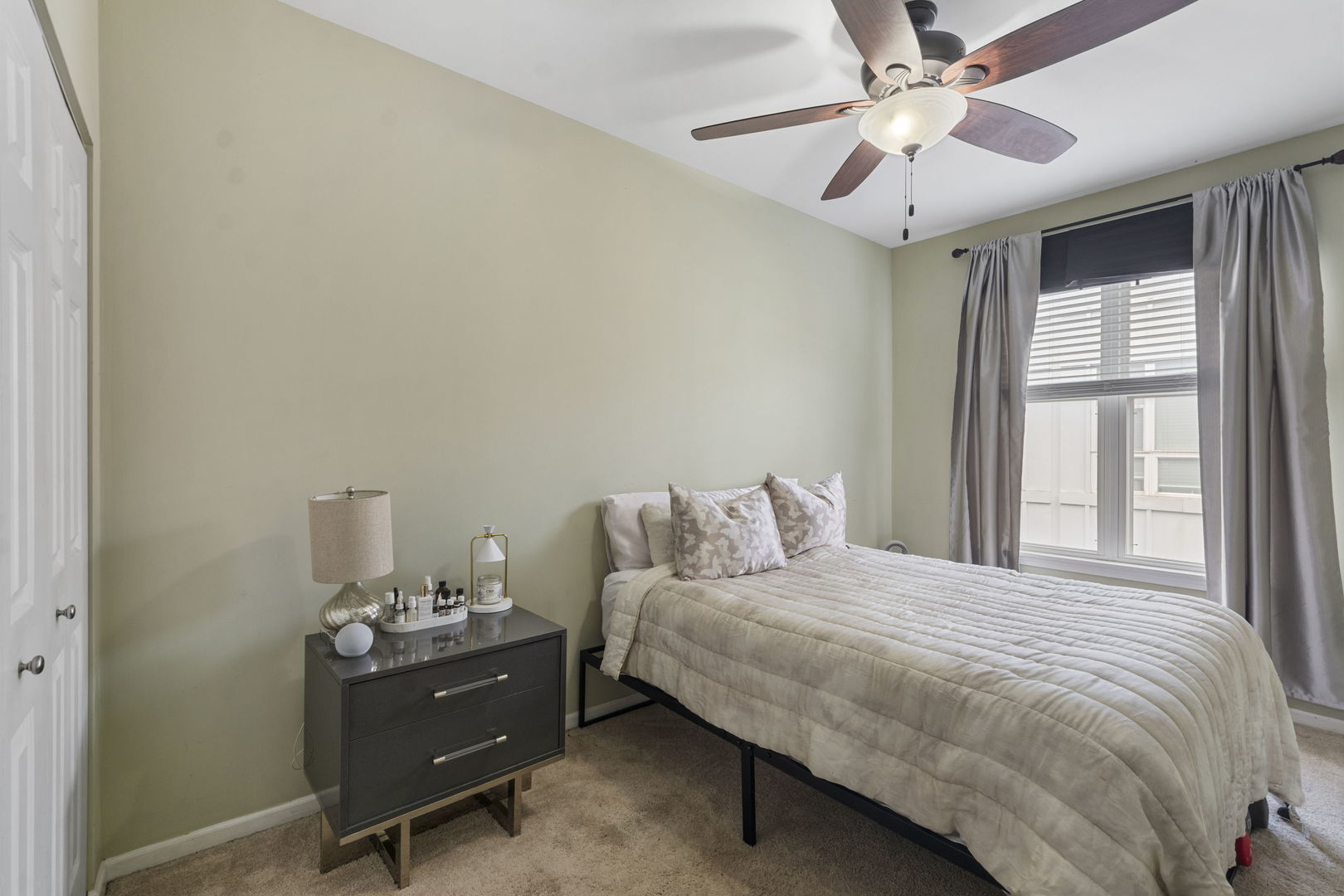 3238 North Kilbourn Avenue, Unit 1 Chicago, IL 60641 - Photo 13 of 17 a bedroom with a bed and a chandelier