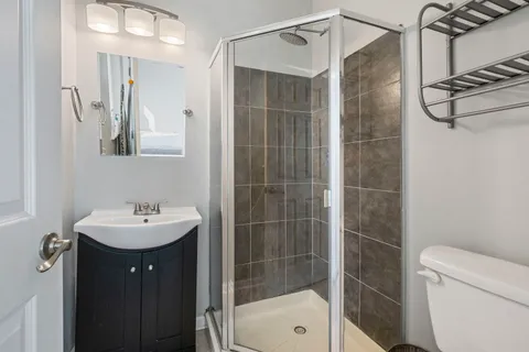 a bathroom with a sink mirror toilet and shower