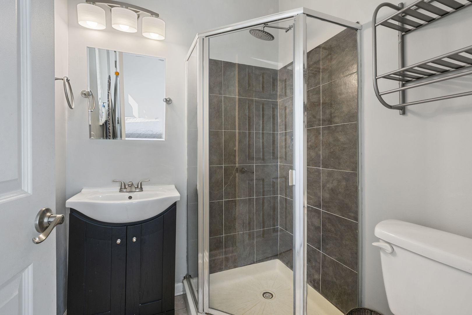 3238 North Kilbourn Avenue, Unit 1 Chicago, IL 60641 - Photo 14 of 17 a bathroom with a sink mirror toilet and shower