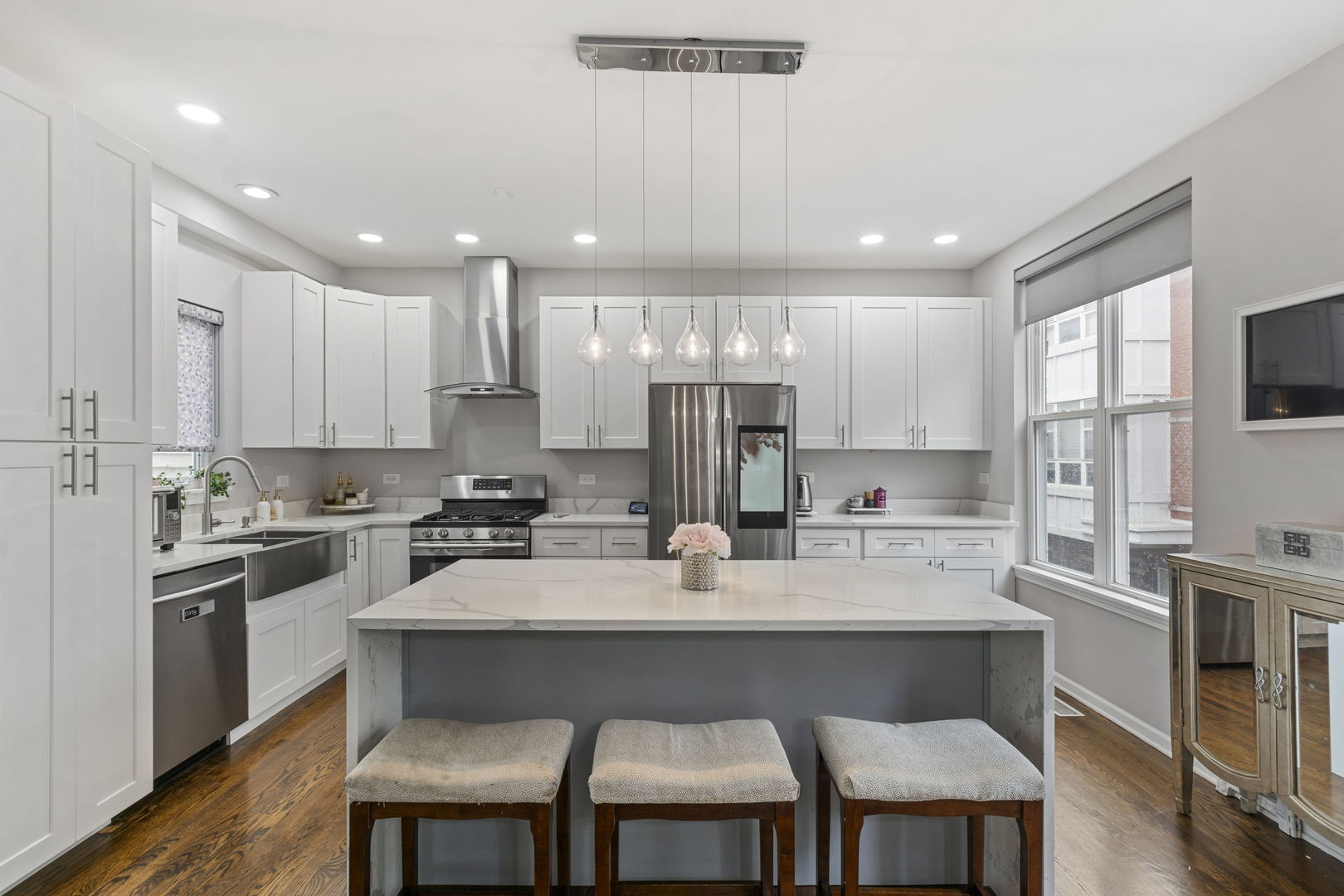 3238 North Kilbourn Avenue, Unit 1 Chicago, IL 60641 - Photo 6 of 17 a kitchen with kitchen island granite countertop a sink and stove
