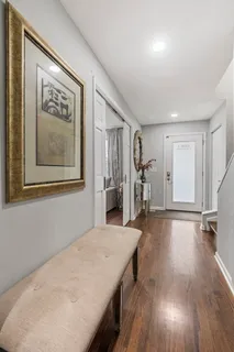 a view of a livingroom with wooden floor and stairs