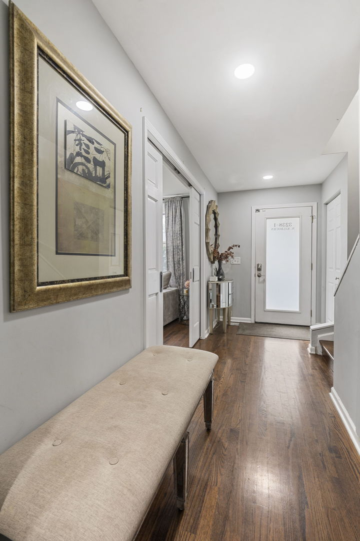 3238 North Kilbourn Avenue, Unit 1 Chicago, IL 60641 - Photo 8 of 17 a view of a livingroom with wooden floor and stairs