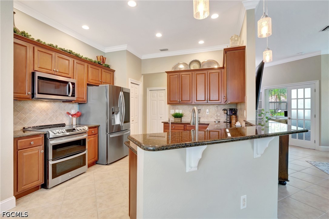 11230 Suffield Street Fort Myers, FL 33913 - Photo 10 of 42 a kitchen with stainless steel appliances granite countertop a stove top oven a sink and dishwasher