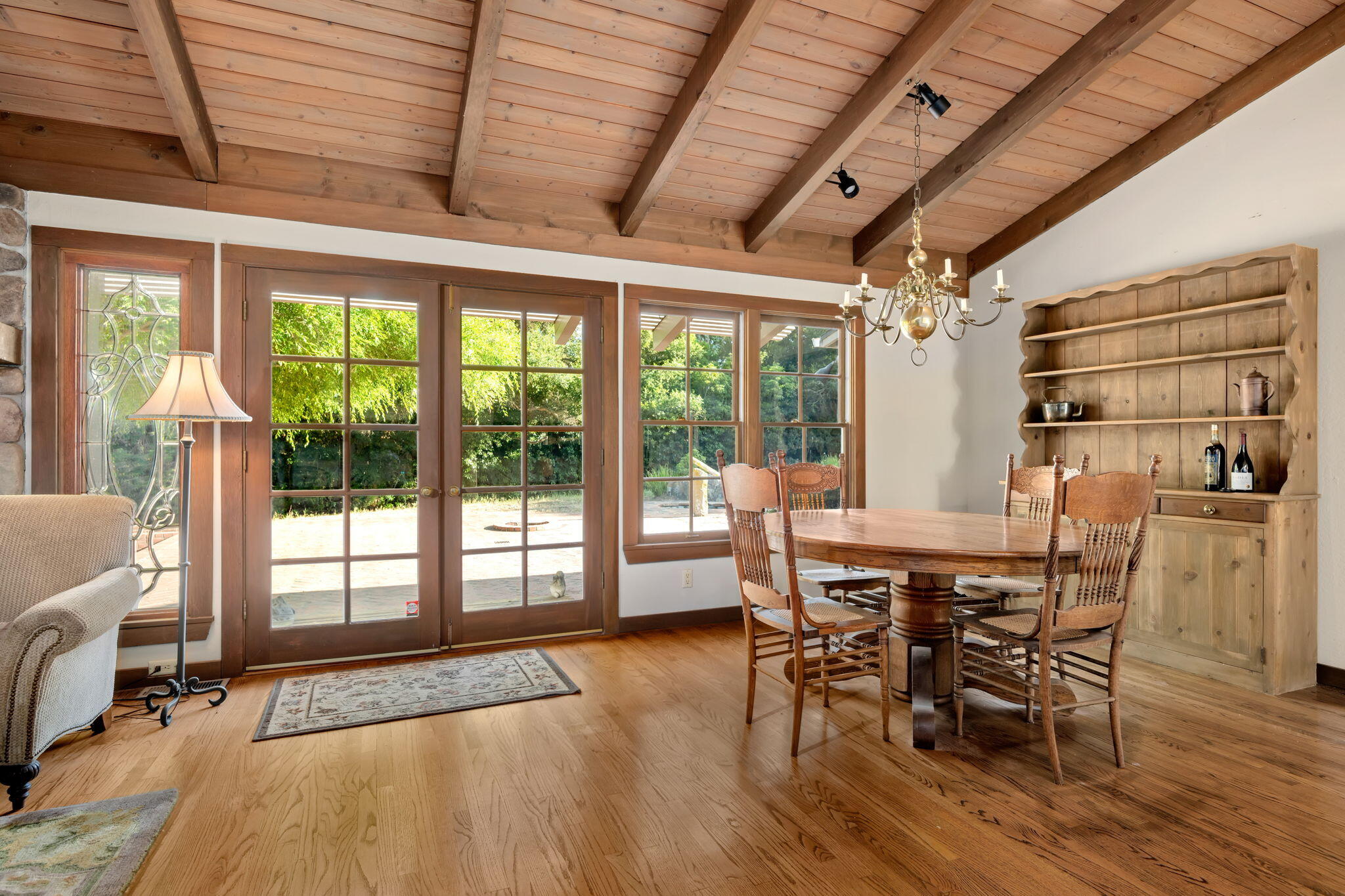1445 School House Road Montecito, CA 93108 - Photo 12 of 53 a dining room with furniture large windows and wooden floor
