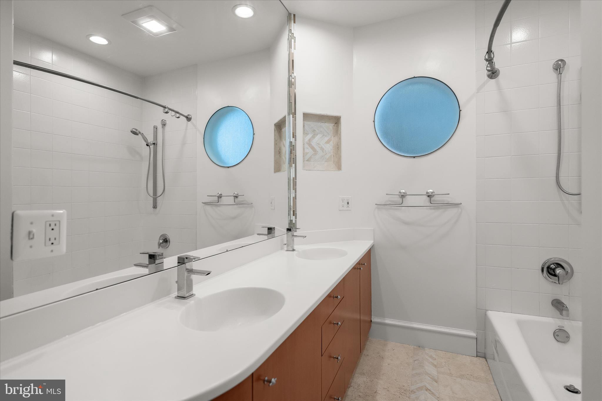 5104 Scarsdale Road Bethesda, MD 20816 - Photo 49 of 68 a bathroom with a double vanity sink and a mirror