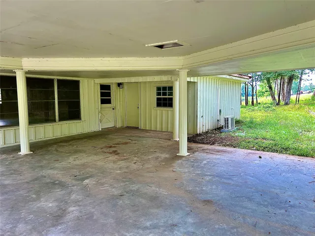 an empty room with yard and outdoor seating