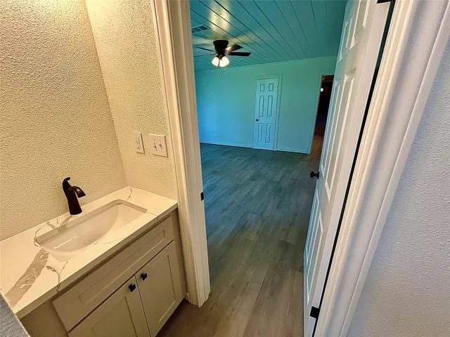 a bathroom with a granite countertop sink and a mirror