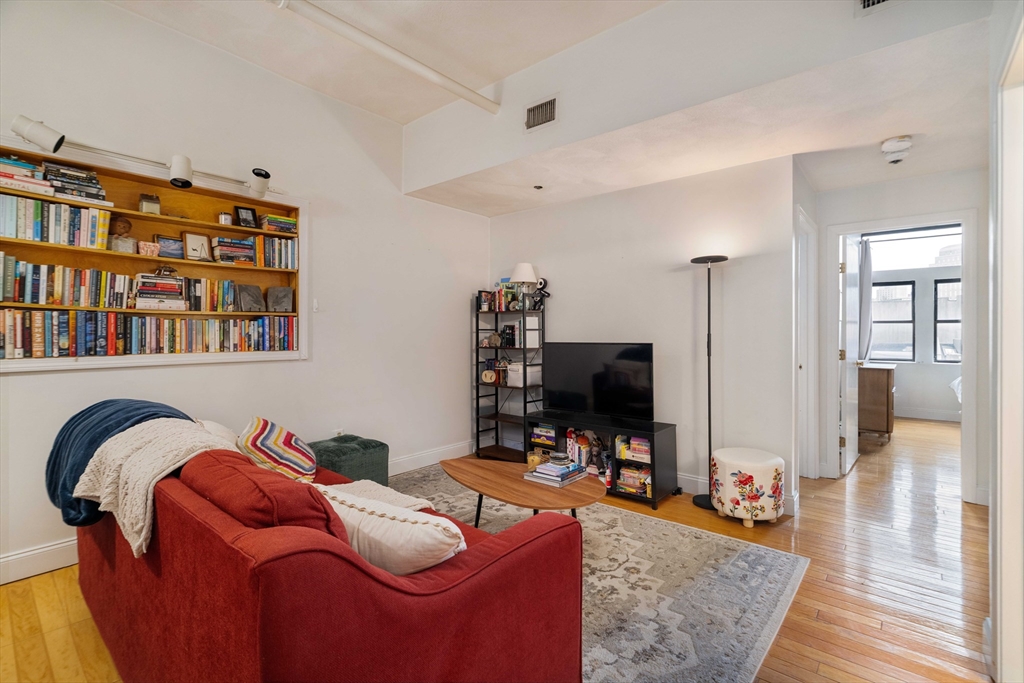 188 North Street, Unit 53 Boston, MA 02113 - Photo 2 of 14 a living room with furniture and a flat screen tv