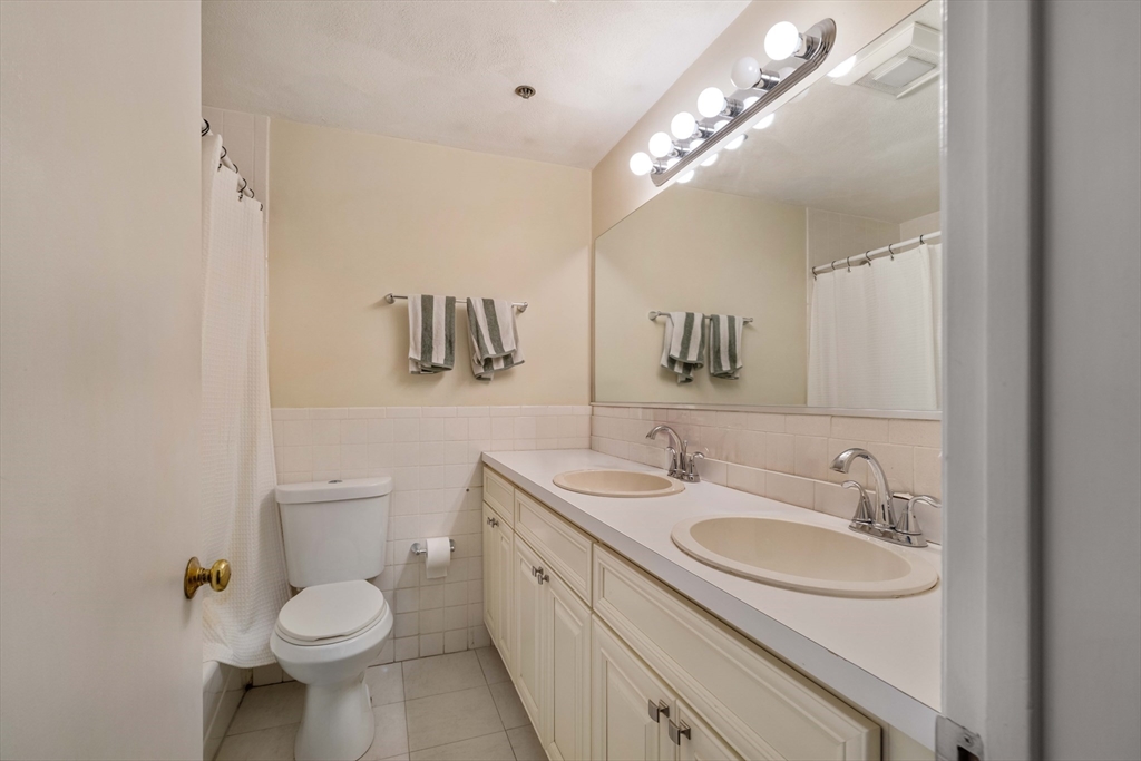 188 North Street, Unit 53 Boston, MA 02113 - Photo 4 of 14 a bathroom with a toilet sink and mirror