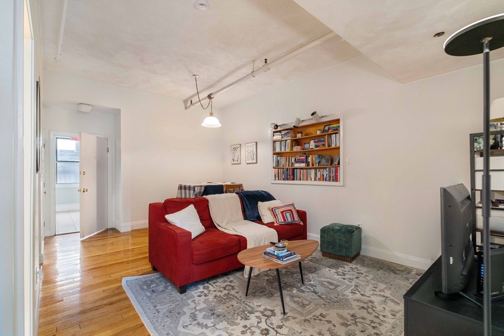 188 North Street, Unit 53 Boston, MA 02113 - Photo 5 of 14 a living room with furniture and a flat screen tv