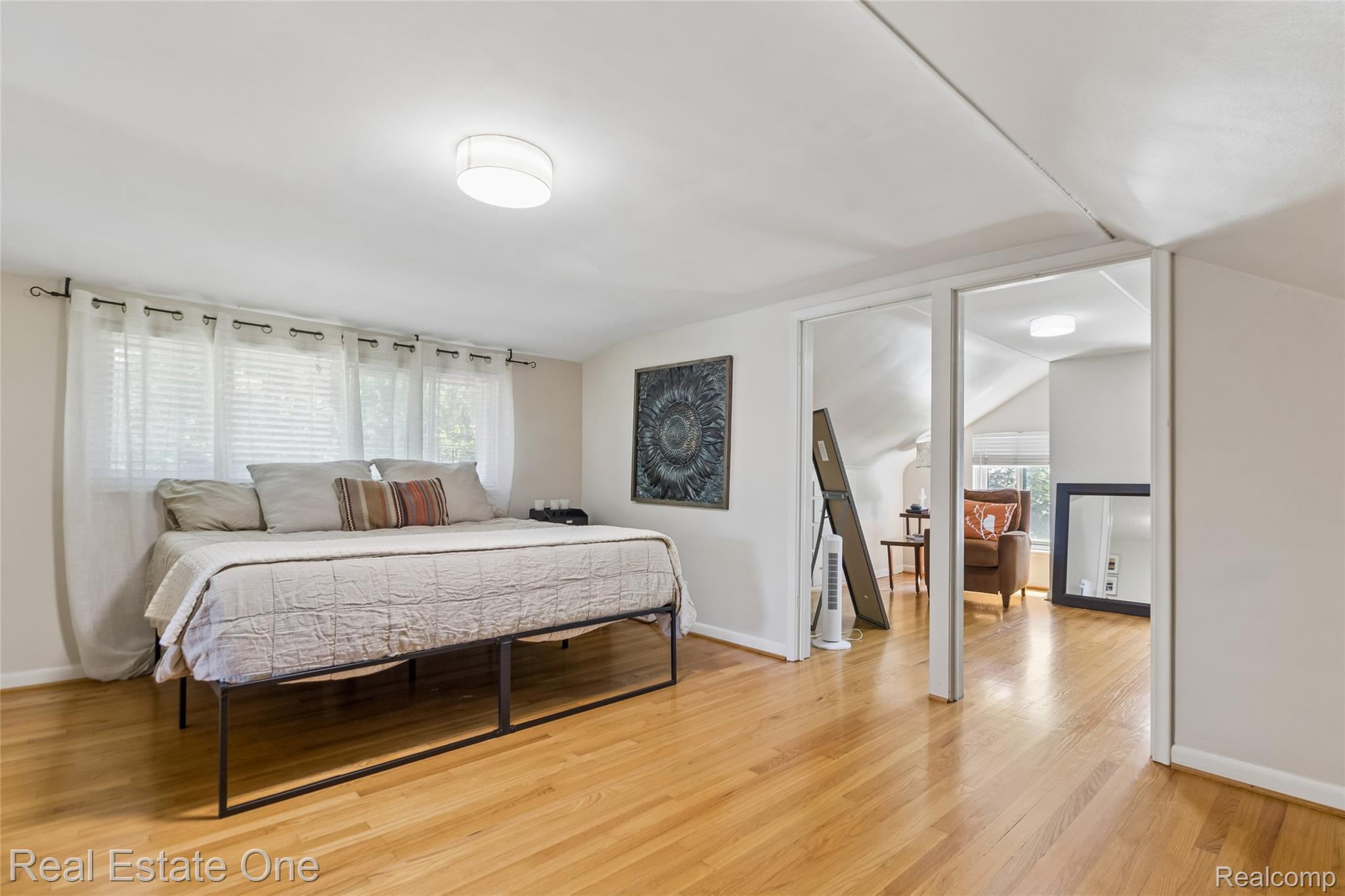 2189 Devonshire Road Bloomfield Hills, MI 48302 - Photo 27 of 50 Hardwood flooring throughout, featuring a bright room with multiple windows and a flush mount ceiling light