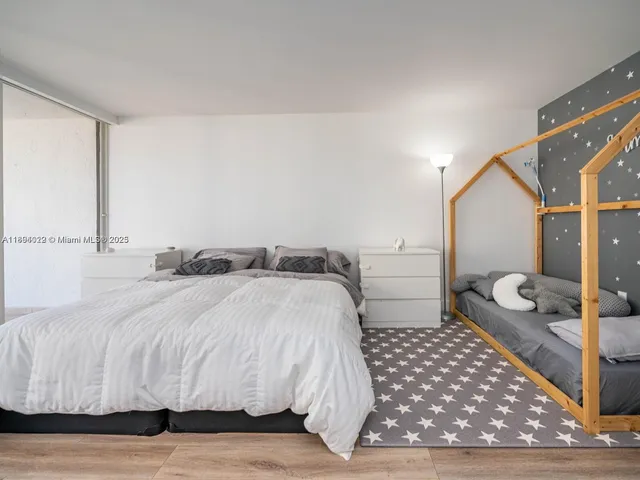 a bedroom with a large bed and a walk in closet