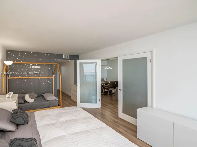 a bedroom with a bed and a large window