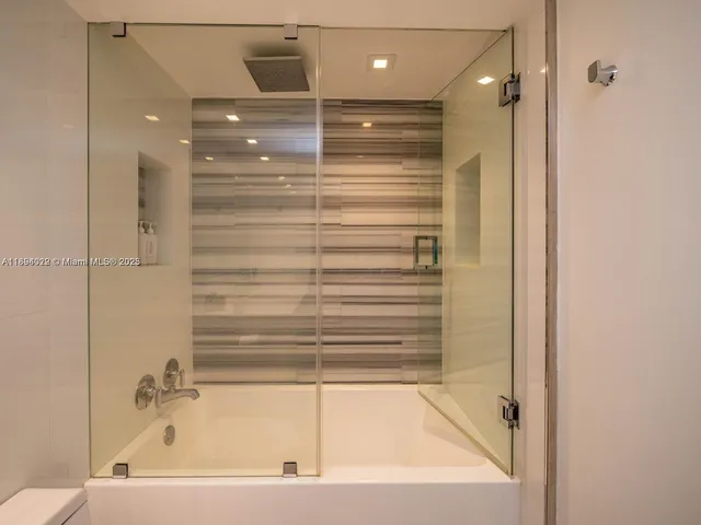 a bathroom with a bathtub and a shower