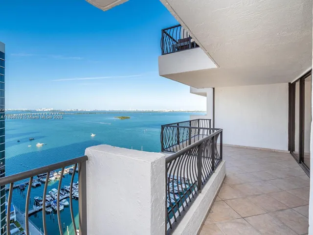 a view of a living room and kitchen with a fireplace