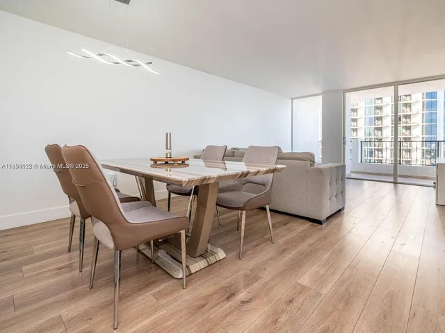 a dining room with furniture and wooden floor