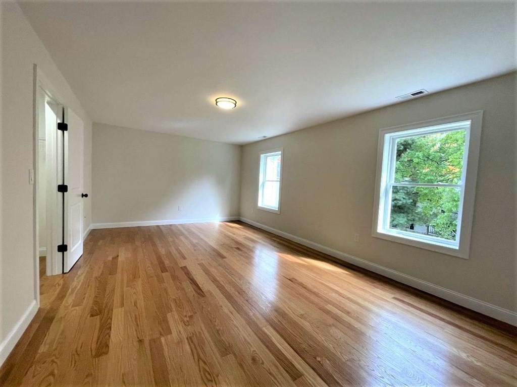 28 Line Road, Unit 1 Wakefield, MA 01880 - Photo 11 of 20 wooden floor in an empty room with a window