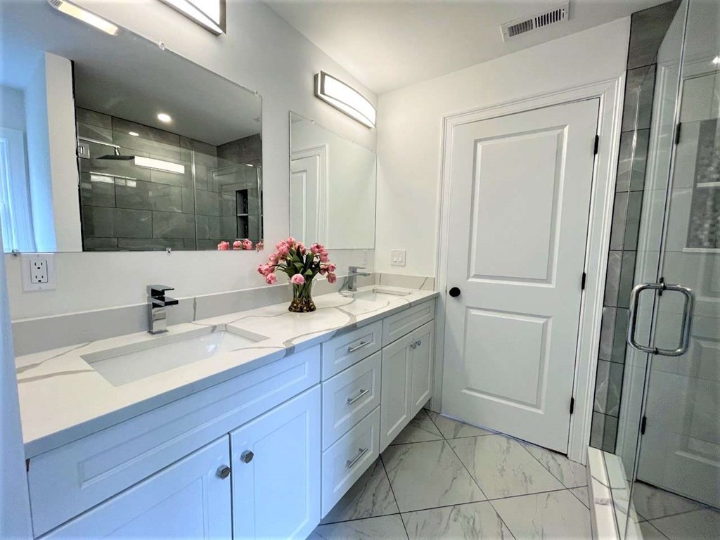 28 Line Road, Unit 1 Wakefield, MA 01880 - Photo 12 of 20 a bathroom with a double vanity sink mirror and shower