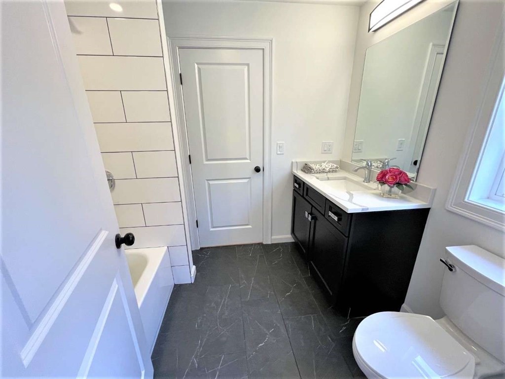 28 Line Road, Unit 1 Wakefield, MA 01880 - Photo 15 of 20 a bathroom with a sink vanity mirror and toilet