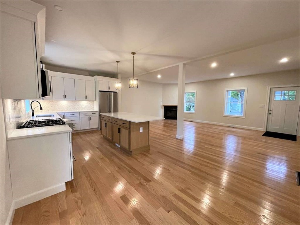28 Line Road, Unit 1 Wakefield, MA 01880 - Photo 4 of 20 a large kitchen with kitchen island a sink stainless steel appliances and cabinets