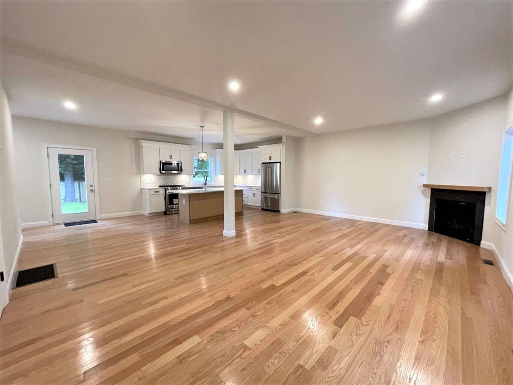 28 Line Road, Unit 1 Wakefield, MA 01880 - Photo 7 of 20 a view of a living room a kitchen and a wooden floor