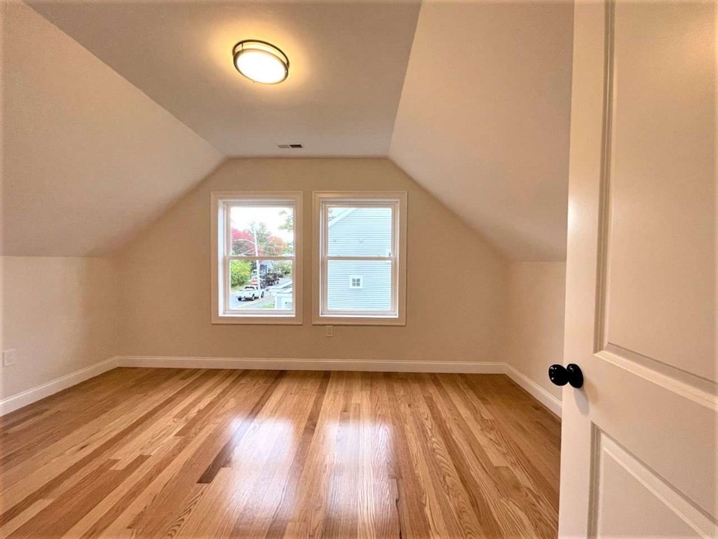 28 Line Road, Unit 1 Wakefield, MA 01880 - Photo 10 of 20 an empty room with wooden floor and windows