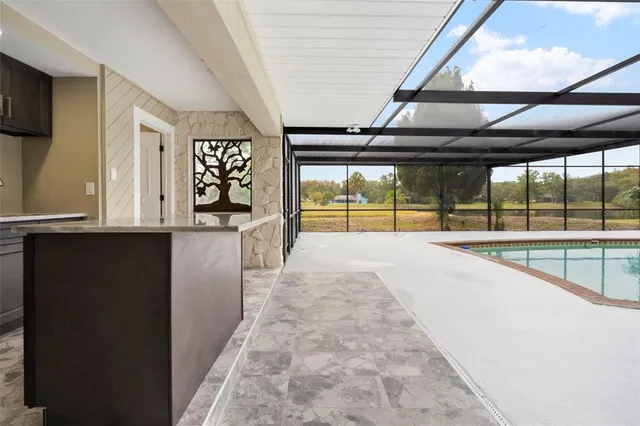 a view of a hallway with wooden floor and a floor to ceiling window