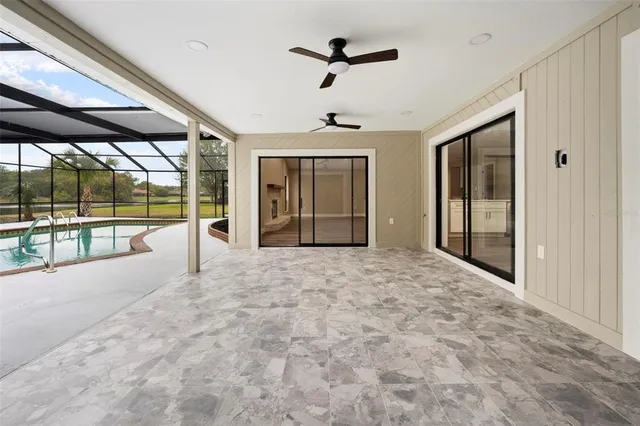 a view of an empty room with a window and fireplace