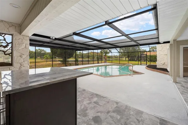 a view of an empty room with a fireplace and a window