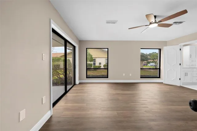 a kitchen with white cabinets appliances and sink
