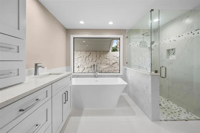 a view of a room with wooden floor a ceiling fan and windows