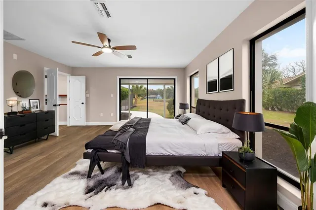 a kitchen with stainless steel appliances a kitchen island hardwood floor sink stove refrigerator and cabinets