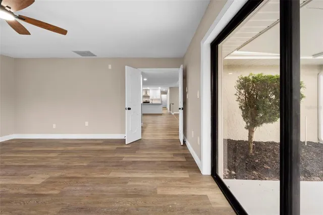 wooden floor in an empty room with a window