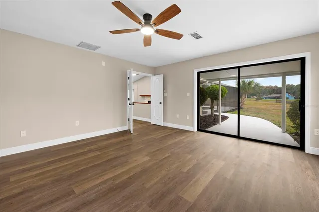 a view of a room with wooden floor and outdoor view
