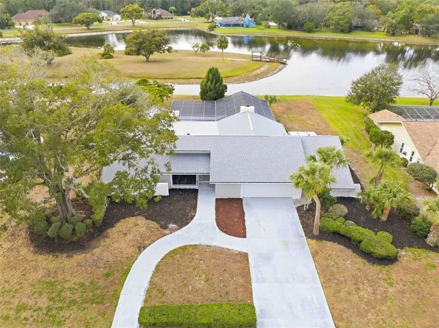 an aerial view of a house with a yard