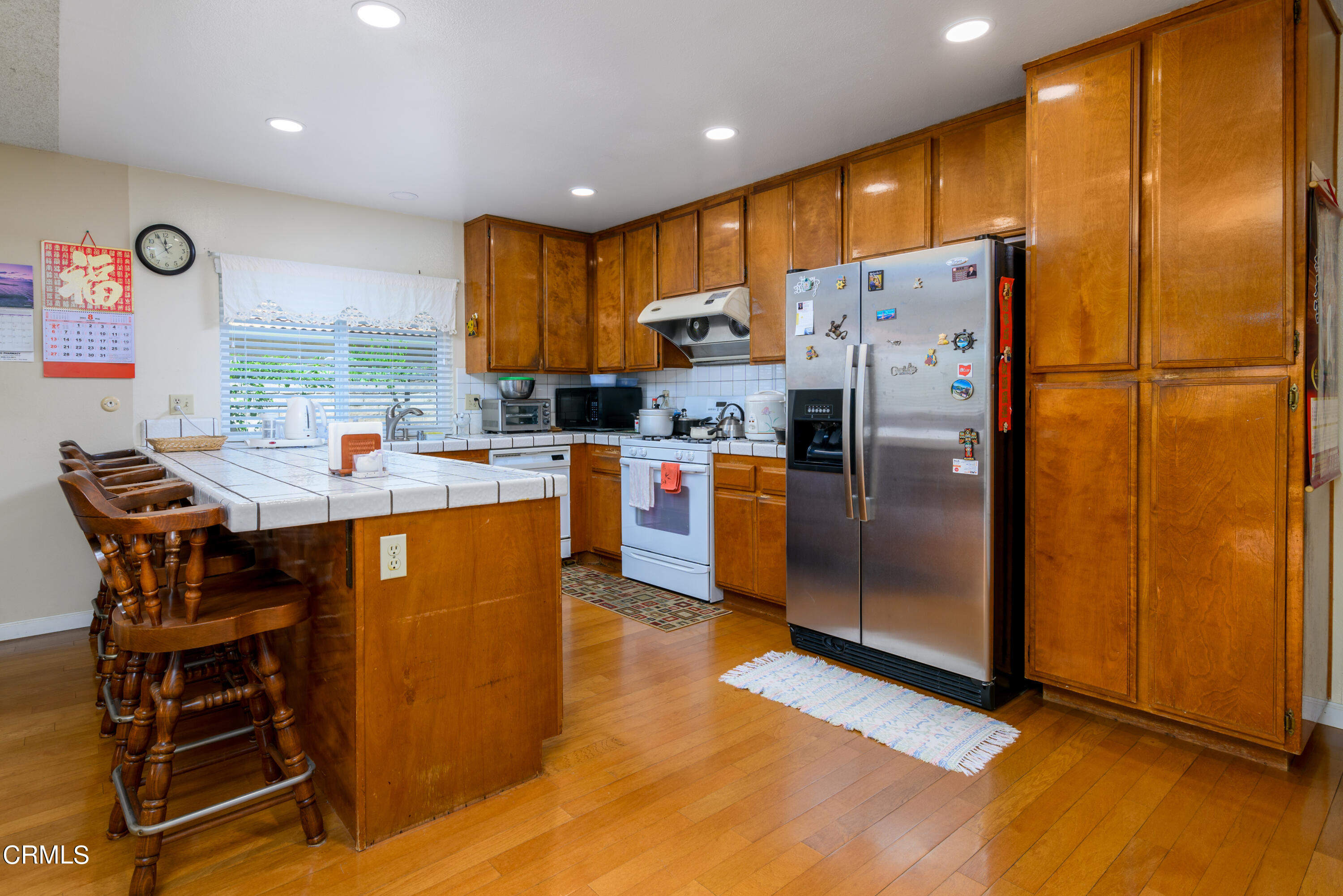 2564 Roxy Street Simi Valley, CA 93065 - Photo 7 of 25 a kitchen with stainless steel appliances a refrigerator a stove a sink and a refrigerator