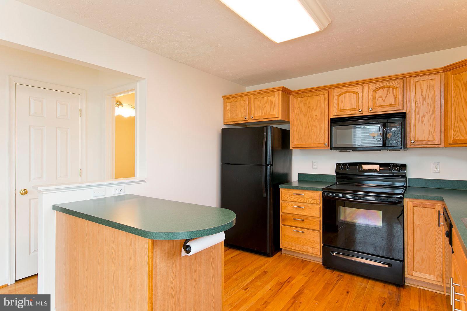 100 Scirocco Lane Winchester, VA 22602 - Photo 12 of 37 a kitchen with stainless steel appliances granite countertop a refrigerator a stove a sink and a microwave