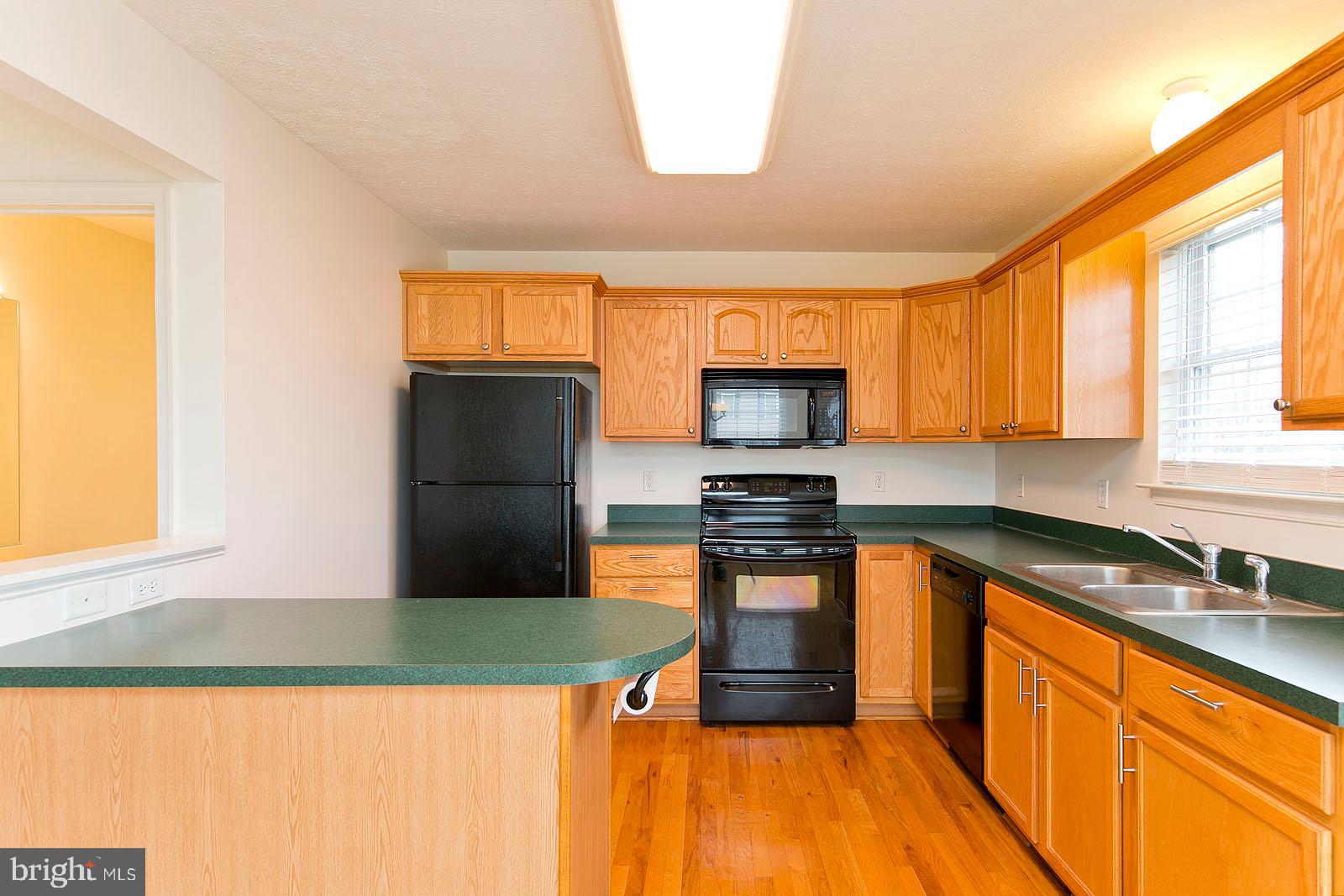 100 Scirocco Lane Winchester, VA 22602 - Photo 13 of 37 a kitchen with stainless steel appliances a stove a sink and a microwave