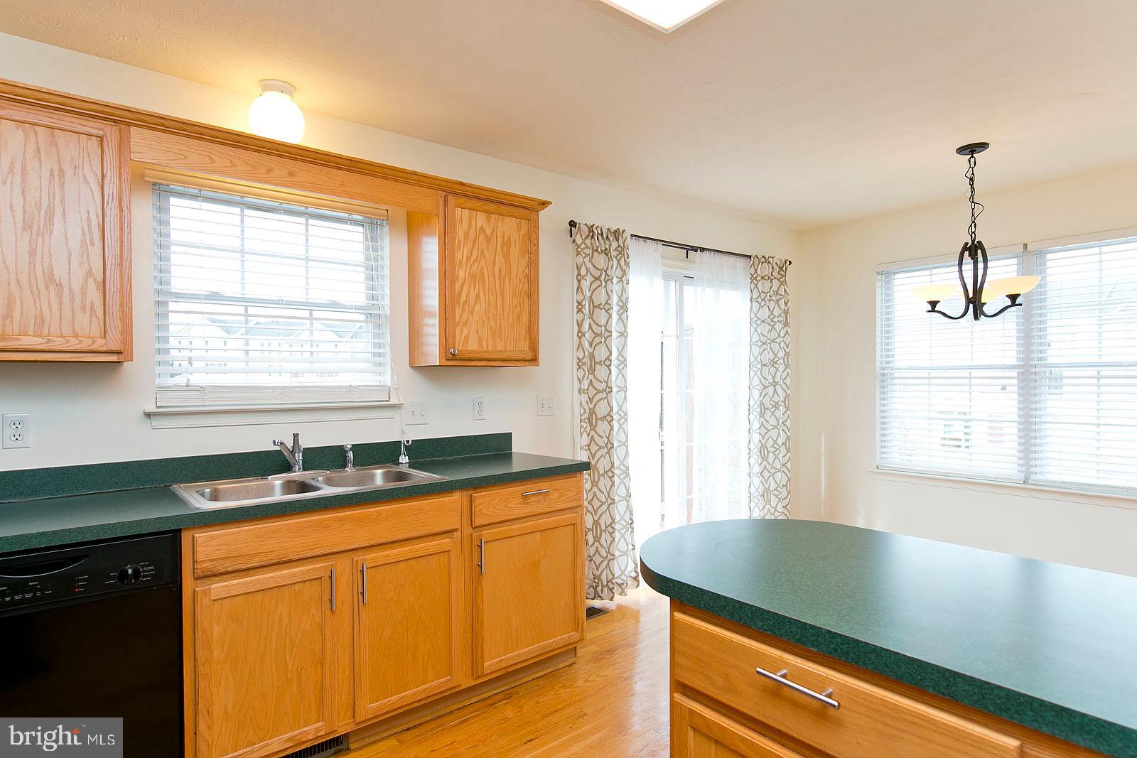 100 Scirocco Lane Winchester, VA 22602 - Photo 16 of 37 a kitchen with stainless steel appliances granite countertop a sink a window and a counter space