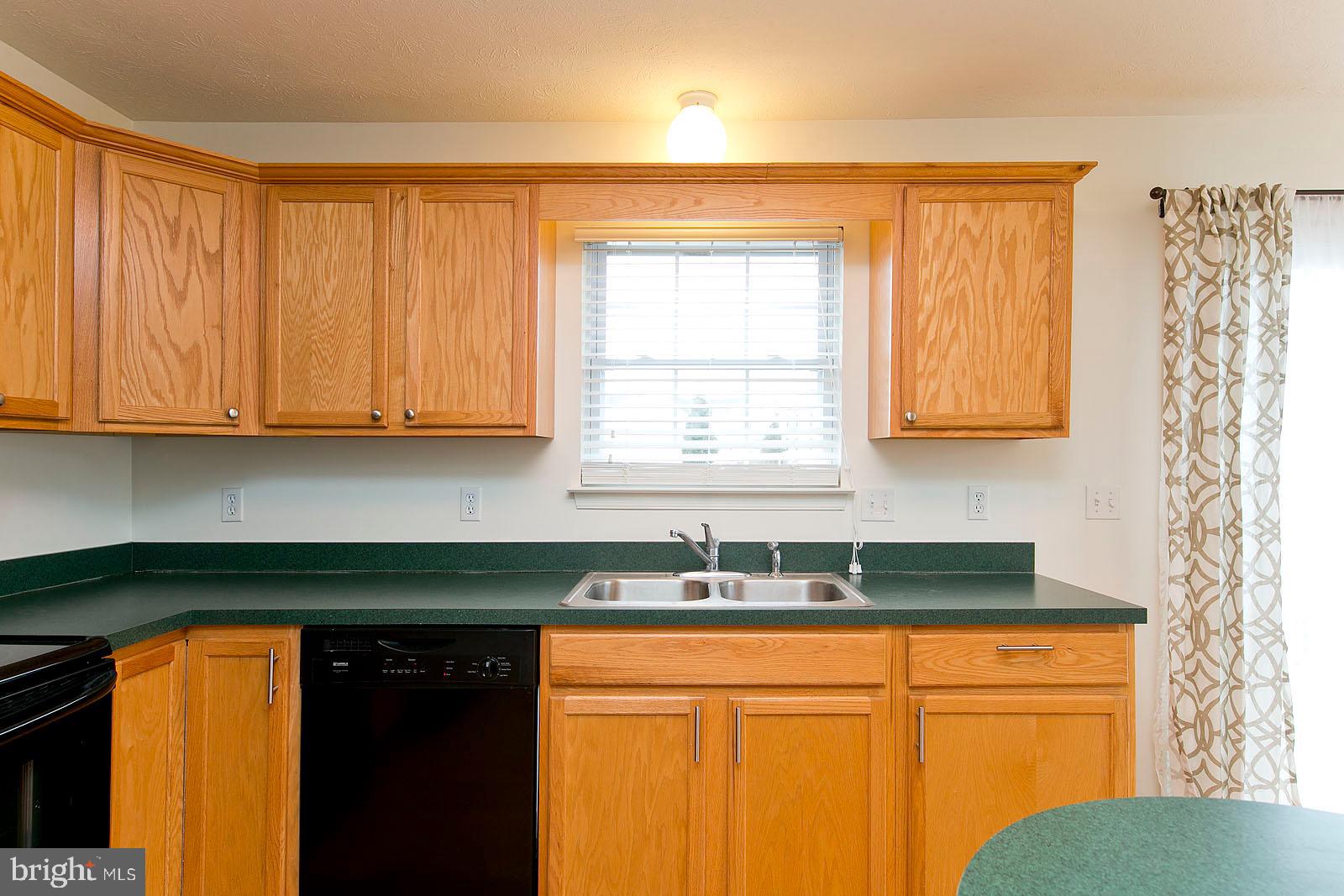 100 Scirocco Lane Winchester, VA 22602 - Photo 17 of 37 a kitchen with stainless steel appliances granite countertop white cabinets sink and a granite counter top