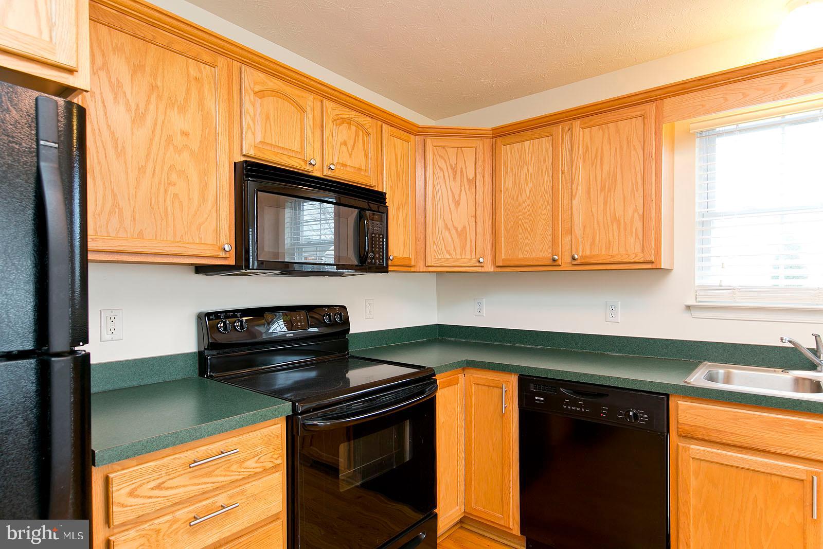 100 Scirocco Lane Winchester, VA 22602 - Photo 18 of 37 a kitchen with granite countertop cabinets stainless steel appliances a sink and a window