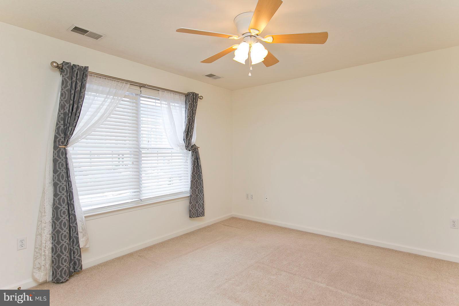 100 Scirocco Lane Winchester, VA 22602 - Photo 19 of 37 an empty room with a window and a fan