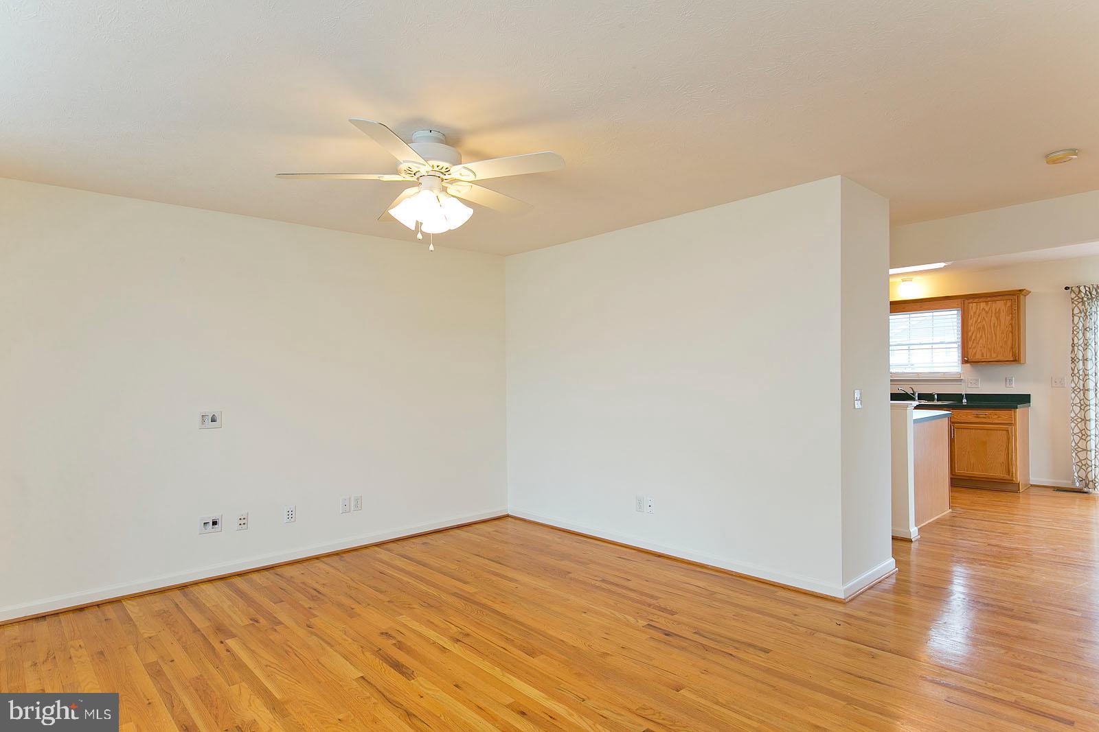 100 Scirocco Lane Winchester, VA 22602 - Photo 2 of 37 a view of a kitchen with wooden floor and a ceiling fan