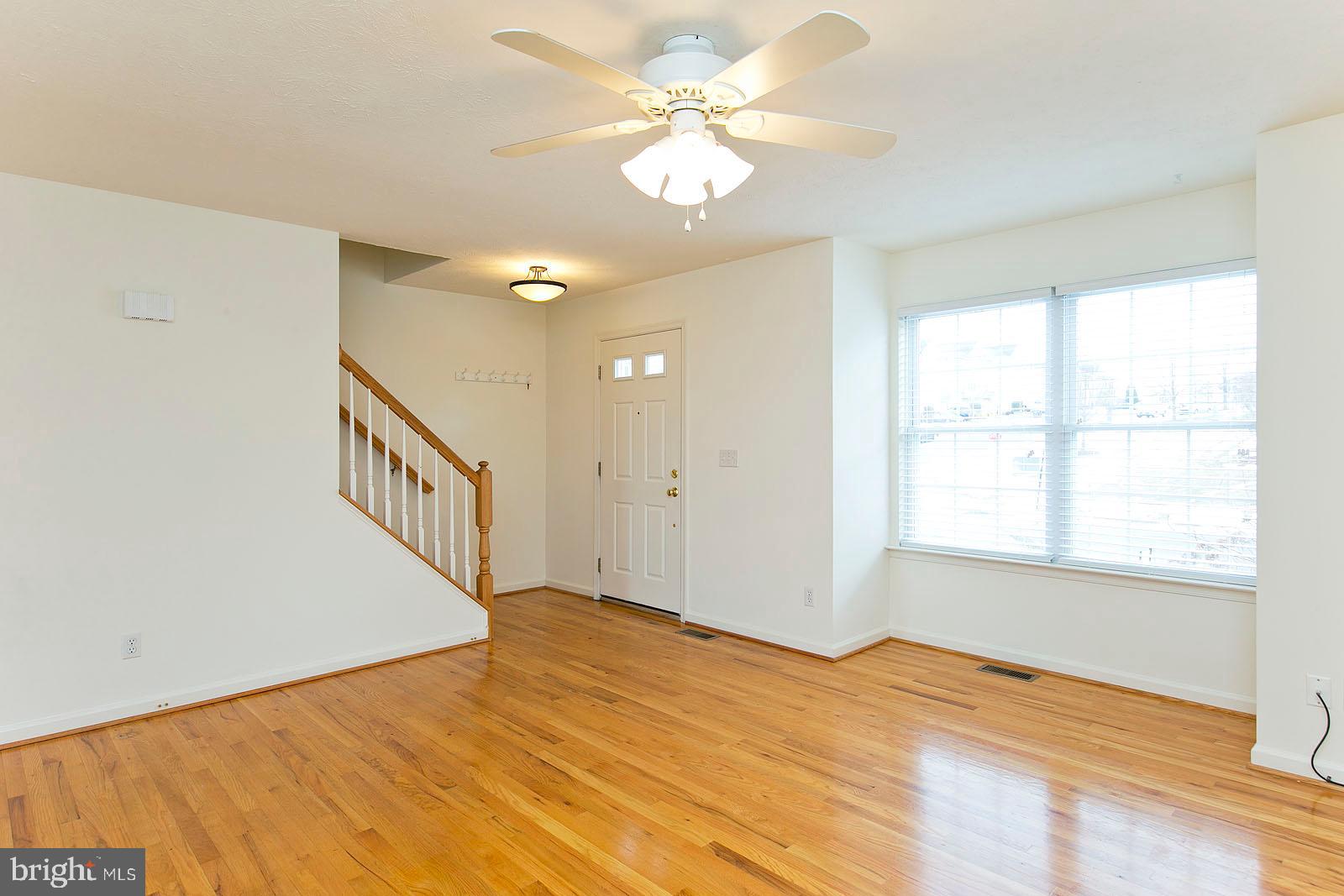 100 Scirocco Lane Winchester, VA 22602 - Photo 4 of 37 a view of an empty room with a window and wooden floor