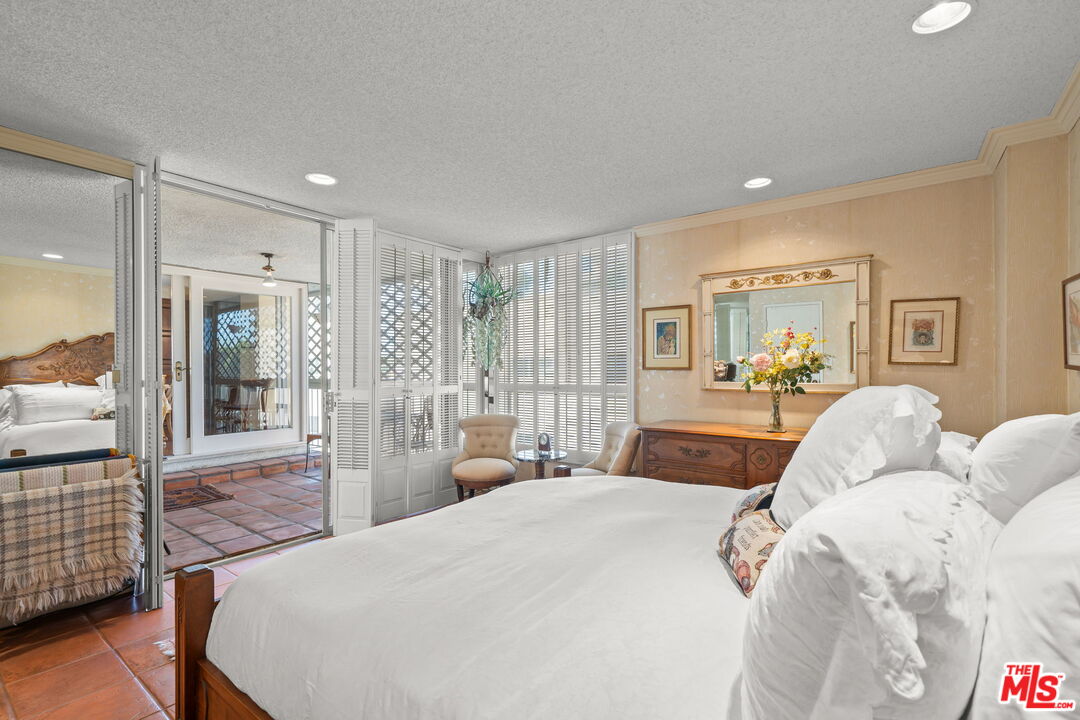 321 North Oakhurst Drive, Unit 403 Beverly Hills, CA 90210 - Photo 11 of 42 a bedroom with a large bed and a couch