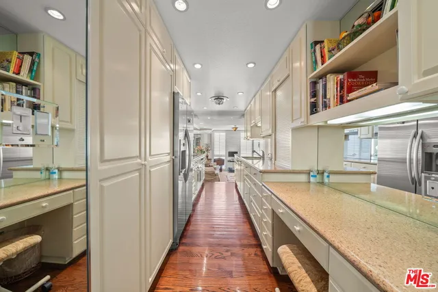 a view of a kitchen with stainless steel appliances granite countertop a refrigerator and a sink