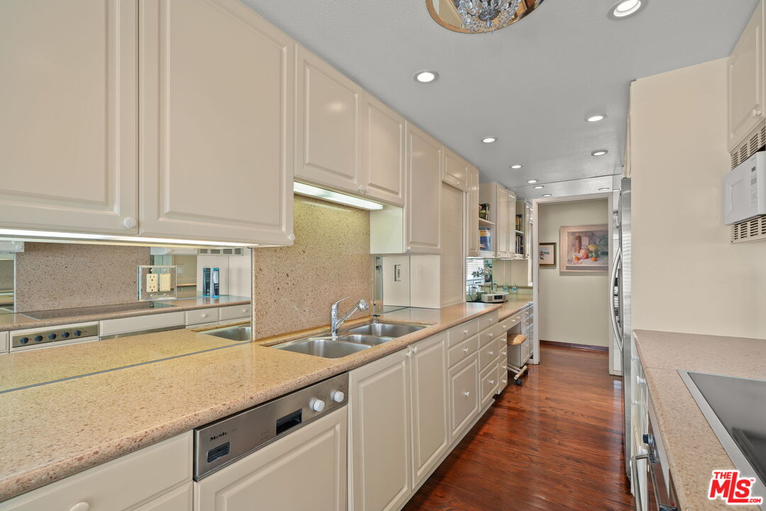 321 North Oakhurst Drive, Unit 403 Beverly Hills, CA 90210 - Photo 14 of 42 a large white kitchen with a sink and dishwasher