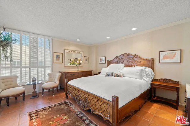 a bedroom with a bed and a couch