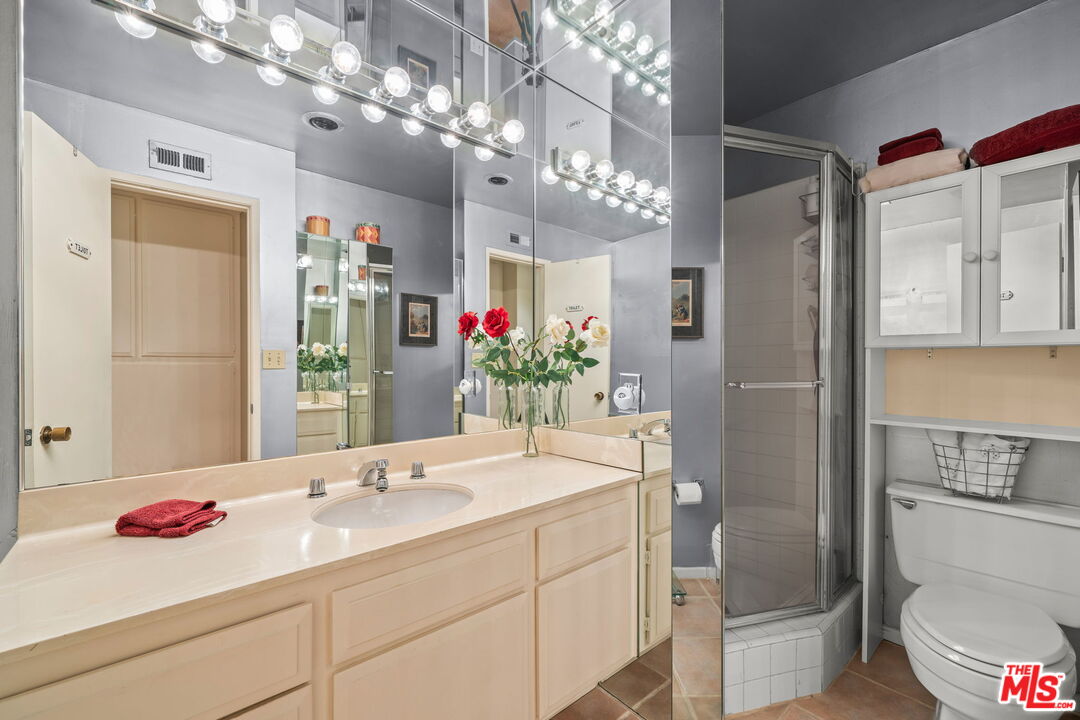 321 North Oakhurst Drive, Unit 403 Beverly Hills, CA 90210 - Photo 20 of 42 a bathroom with a shower sink and mirror