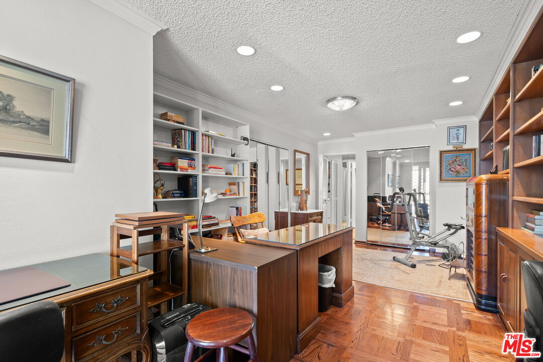 321 North Oakhurst Drive, Unit 403 Beverly Hills, CA 90210 - Photo 22 of 42 a work room with furniture a bookshelf and a window
